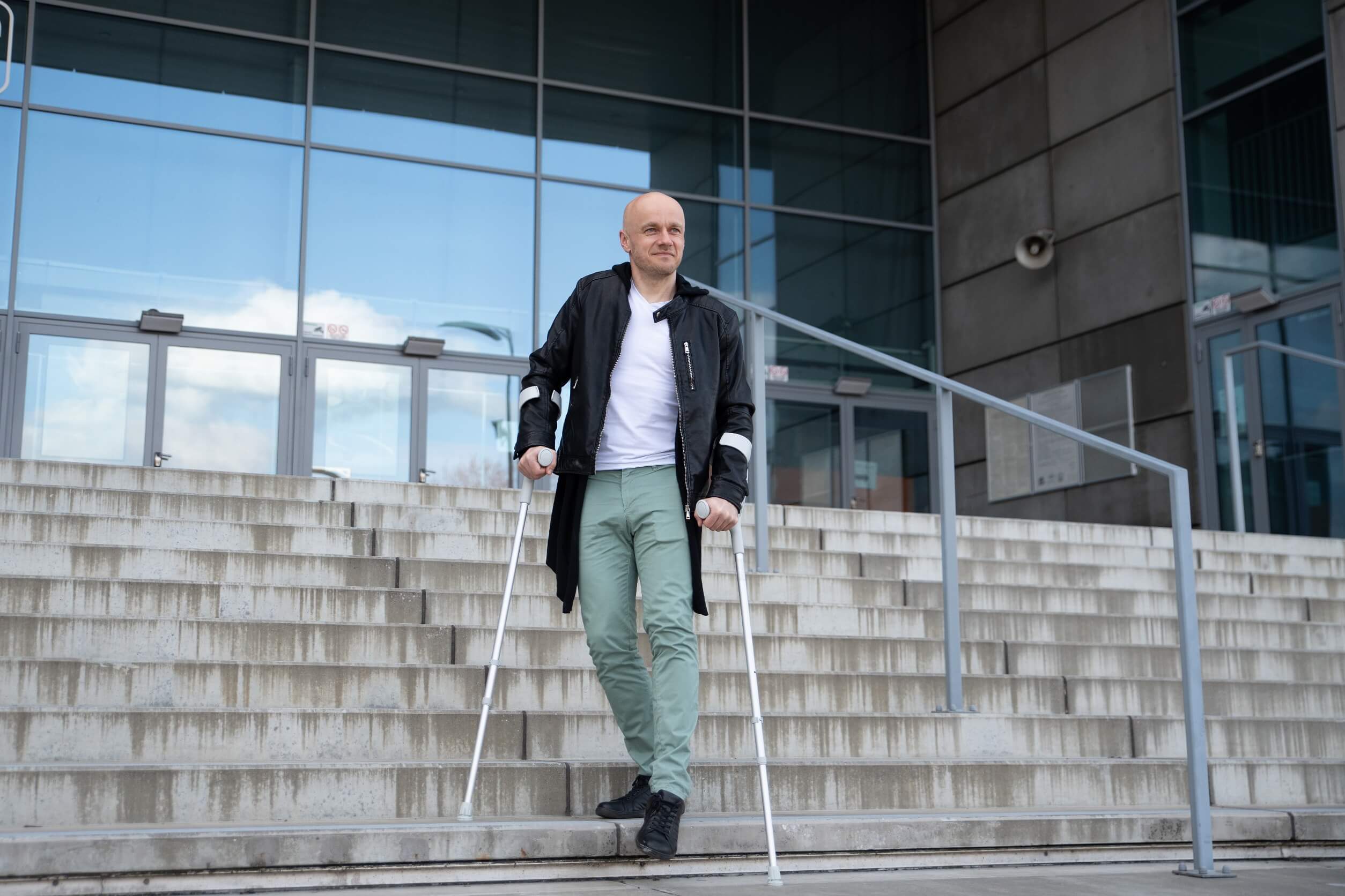 physically disabled man going down the stairs