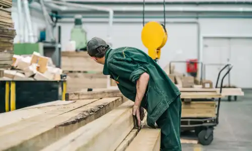 A construction worker complets a job in a factory.