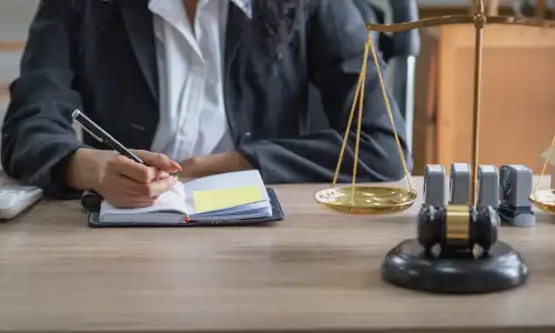 An Okechobee personal injury lawyer takes notes in her office.