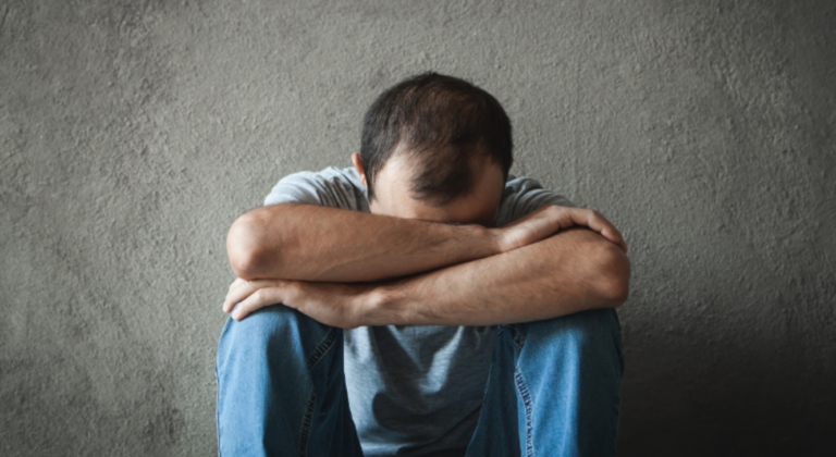 Man sitting down not feeling well