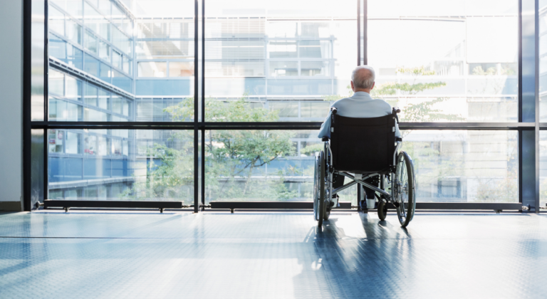 Elderly person in a wheelchair experiencing neglect